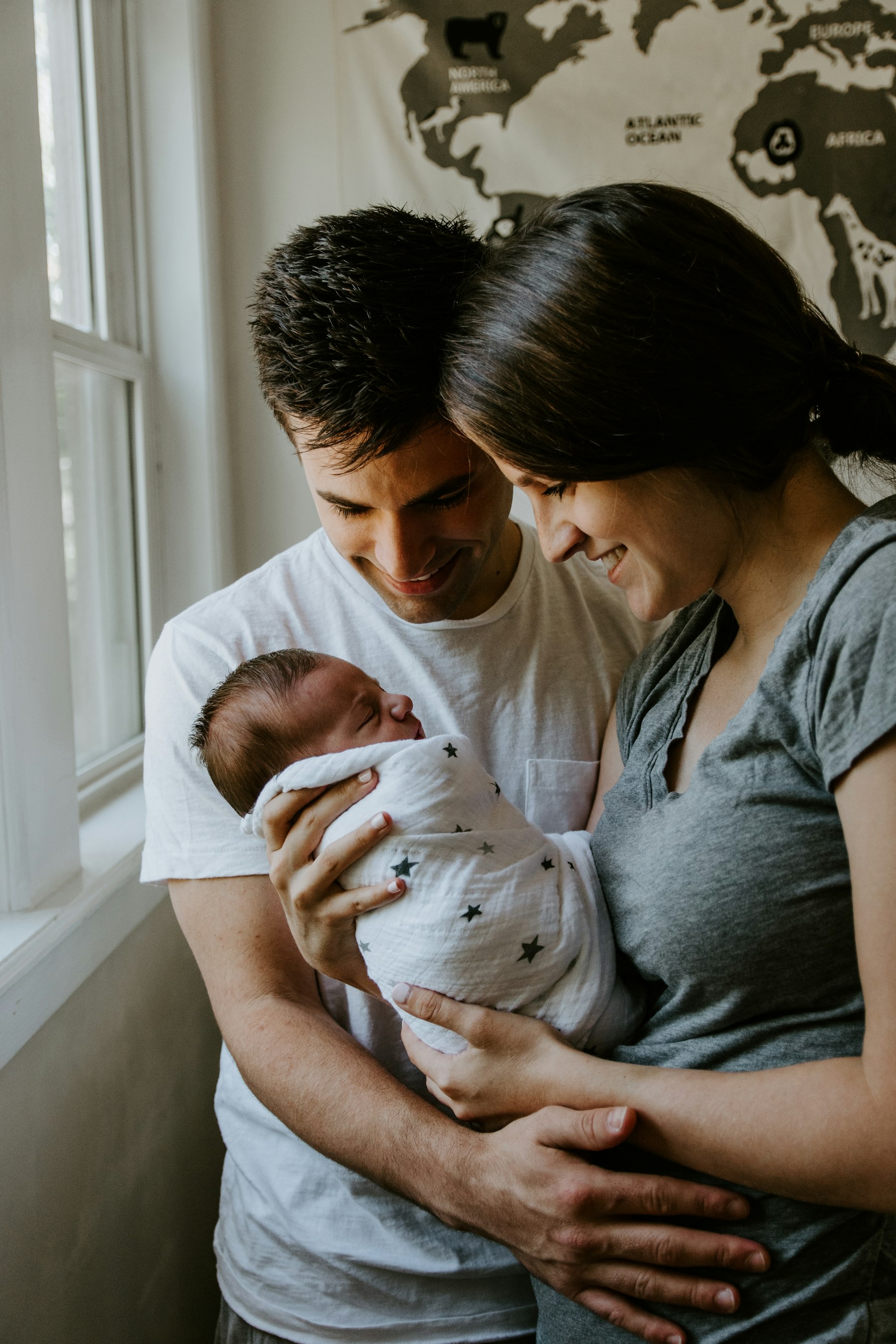 A parent and a young child at home in warm, natural light.
