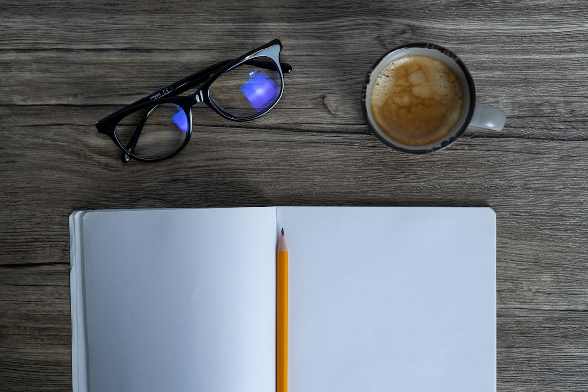 A notebook and coffee beside parenting notes.